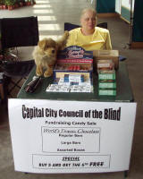 Anna sitting at a table selling candy