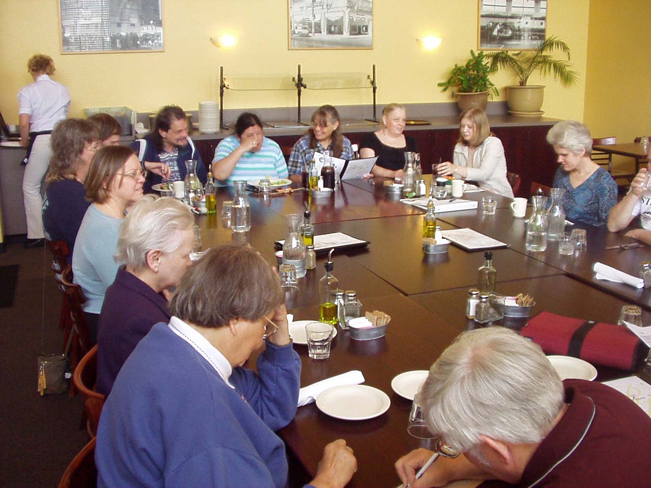 Photo #1 of members and guests sitting around tables.